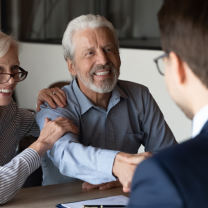 older couple shaking hands with mortgage adviser