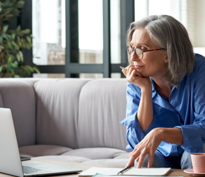 over 55s woman looking at her computer consider a Later Life mortgage