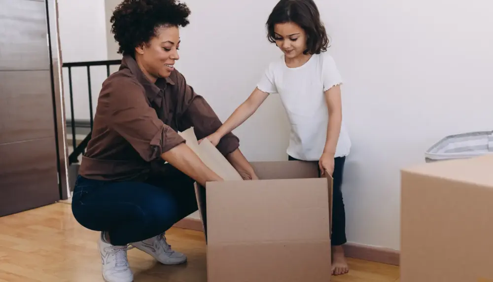 first-time buyer unpacking feeling relieved with delayed start mortgage