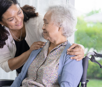 Adult daughter supporting her elderly mother in a wheelchair, symbolising the emotional and practical responsibilities of estate planning and executor duties.