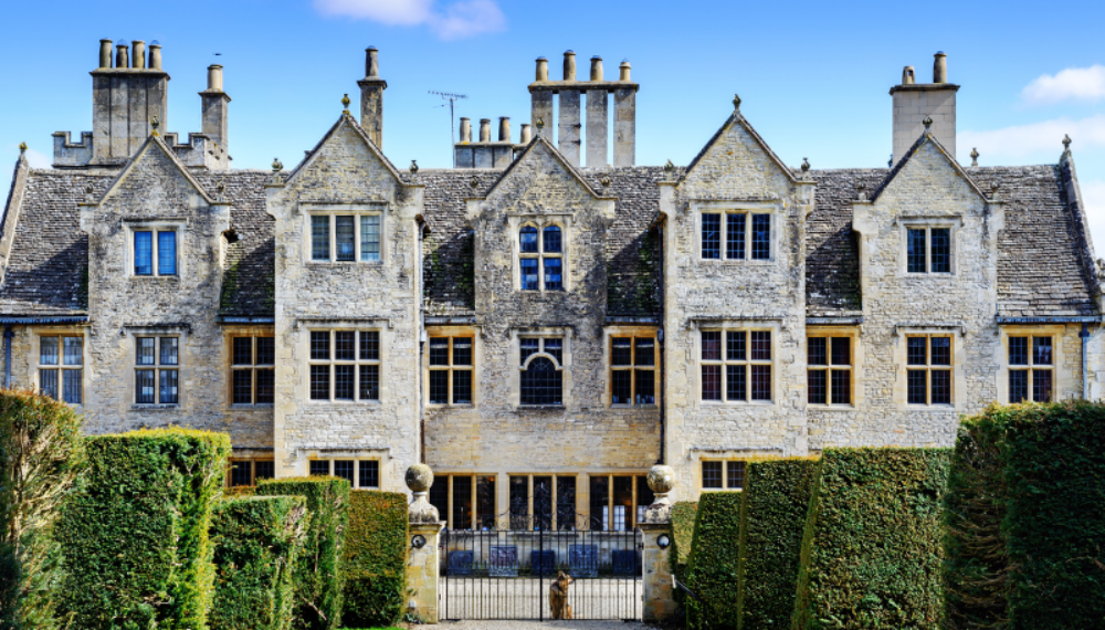 Large historic country house with formal gardens, representing intergenerational wealth planning and private school fee strategies